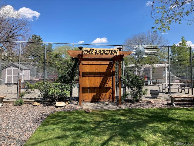 view of play area featuring a gate, a storage shed, and an outdoor structure