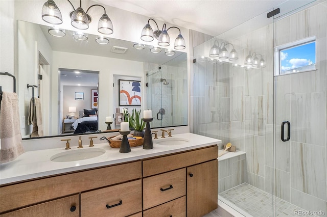 bathroom featuring an enclosed shower, large vanity, and dual sinks