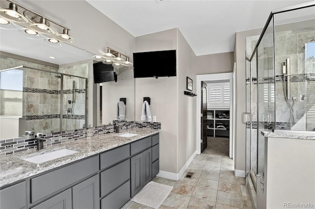 31189 Manitoba Dr, Evergreen, CO 80439 - full bath featuring a shower stall, double vanity, decorative backsplash, and tile patterned flooring