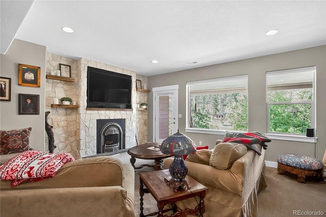 31189 Manitoba Dr, Evergreen, CO 80439 - living area featuring carpet, a stone fireplace, and recessed lighting