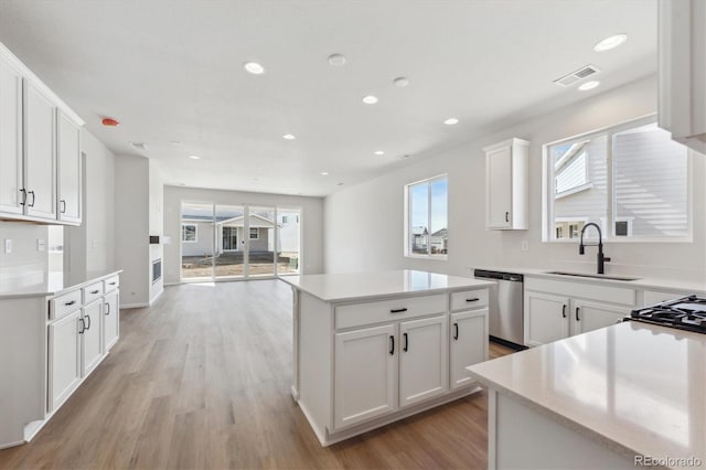 1300 Sienna Peak Cir, Erie, CO 80516 - kitchen featuring light countertops, a sink, a kitchen island, and dishwasher