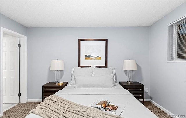 bedroom featuring carpet flooring and baseboards