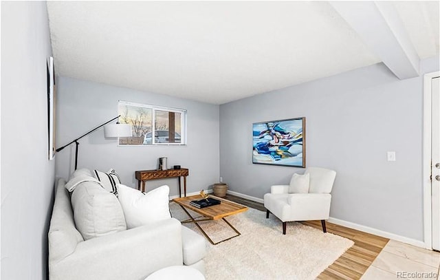 living area with baseboards and light wood finished floors