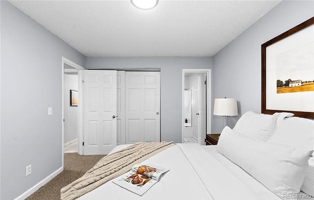 bedroom with baseboards, carpet floors, ensuite bathroom, and a closet