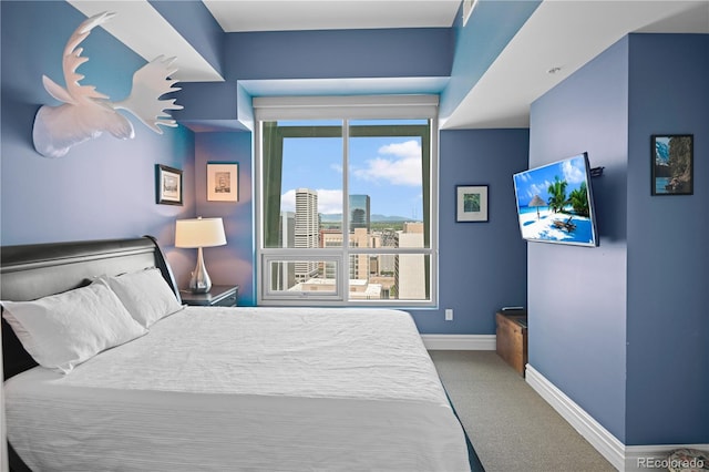 bedroom featuring carpet and baseboards