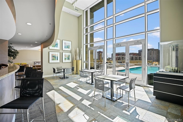 2001 Lincoln St Unit 2420, Denver, CO 80202 - common area featuring a towering ceiling, recessed lighting, and a city view