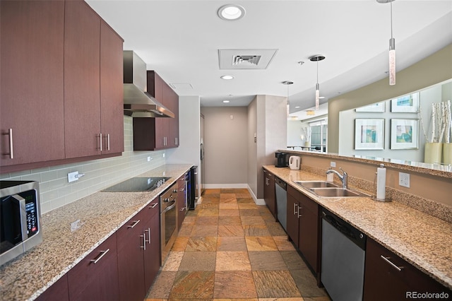 2001 Lincoln St Unit 2420, Denver, CO 80202 - kitchen featuring stainless steel appliances, wall chimney exhaust hood, a sink, baseboards, and stone tile flooring