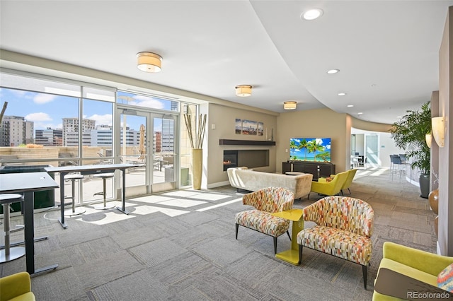 2001 Lincoln St Unit 2420, Denver, CO 80202 - carpeted living area featuring recessed lighting, french doors, baseboards, a view of city, and a warm lit fireplace