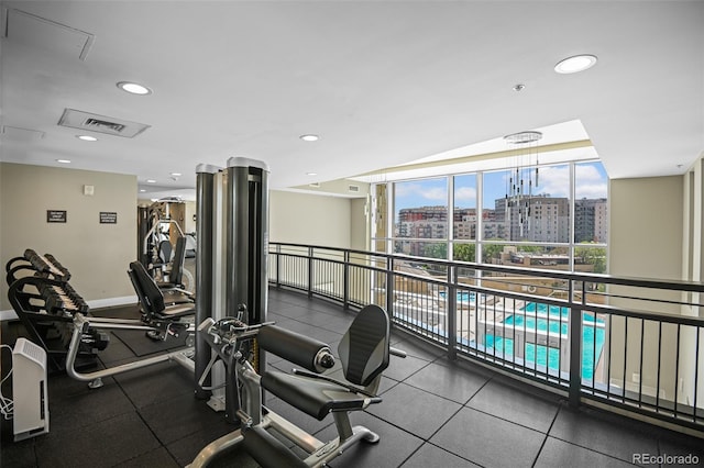 2001 Lincoln St Unit 2420, Denver, CO 80202 - exercise room featuring healthy amount of natural light, a city view, recessed lighting, baseboards, and a wall of windows
