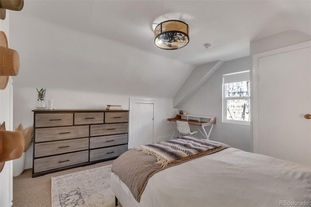 carpeted bedroom featuring lofted ceiling