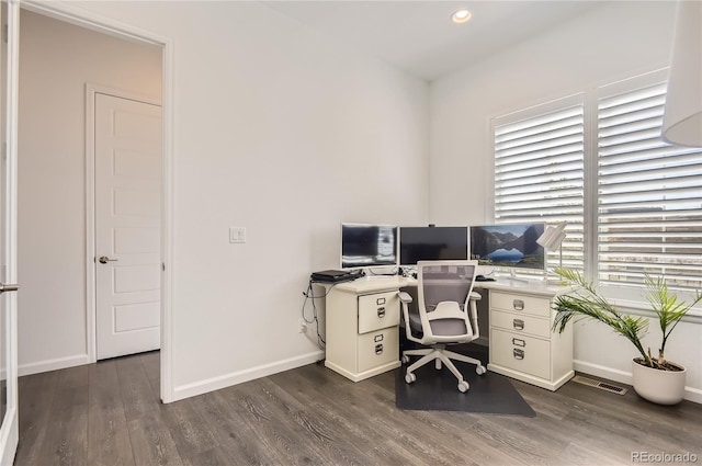 office with dark hardwood / wood-style floors and a healthy amount of sunlight