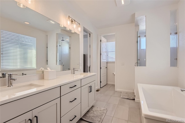 bathroom with tile patterned flooring, vanity, and separate shower and tub