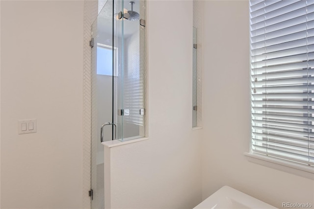 bathroom featuring a wealth of natural light and an enclosed shower