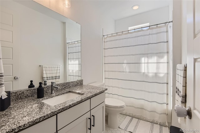 full bathroom featuring a wealth of natural light, tile patterned flooring, vanity, and toilet