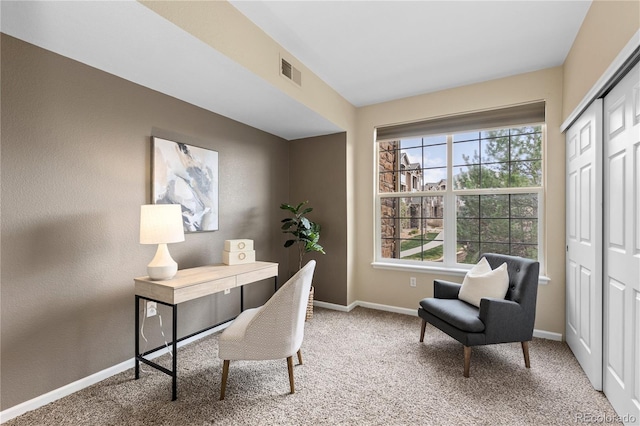 carpeted office with baseboards and visible vents