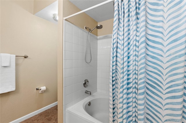 bathroom featuring shower / bathtub combination with curtain, tile patterned flooring, and baseboards