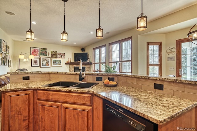 kitchen featuring light stone counters, a textured ceiling, a sink, open floor plan, and black dishwasher
