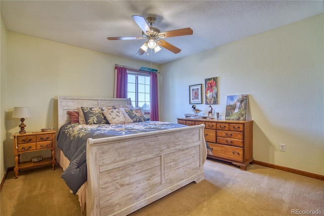 bedroom with light carpet, a ceiling fan, baseboards, and a textured ceiling