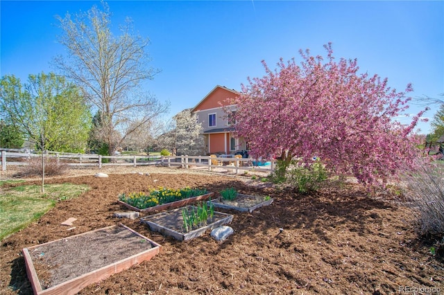 view of yard with a garden and fence
