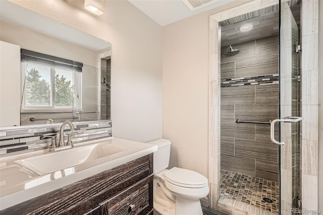 bathroom with vanity, an enclosed shower, and toilet