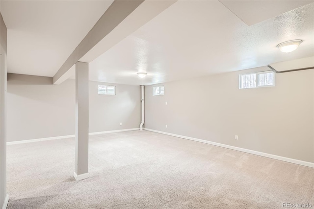 basement with carpet floors and a textured ceiling