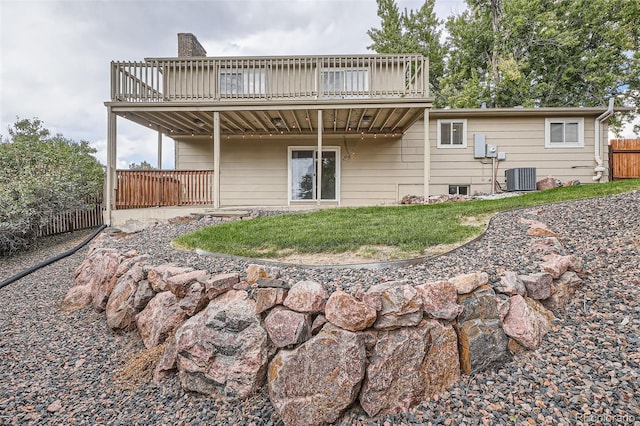 back of house featuring a wooden deck, central AC unit, and a yard