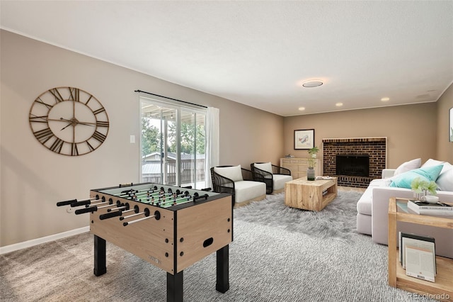 playroom with a brick fireplace and carpet floors