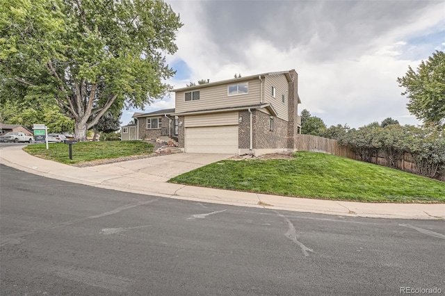 front of property with a garage and a front lawn