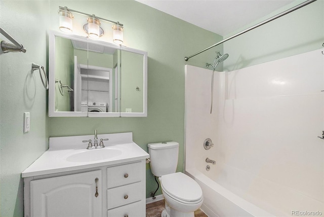 bathroom with washer / clothes dryer, vanity, toilet, and  shower combination