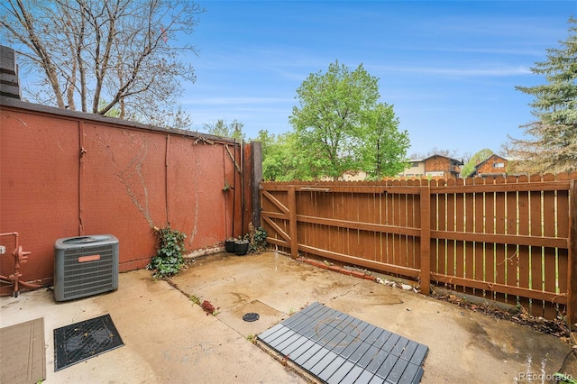 view of patio featuring central air condition unit and fence