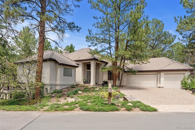 474 Silbrico Way, Castle Rock, CO 80108 - view of front of house with a tile roof, stucco siding, decorative driveway, and an attached garage