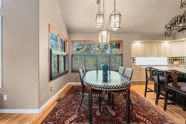 474 Silbrico Way, Castle Rock, CO 80108 - dining area with light wood-type flooring, lofted ceiling, and baseboards