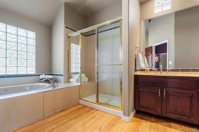 474 Silbrico Way, Castle Rock, CO 80108 - full bath with vanity, a garden tub, a stall shower, and wood finished floors