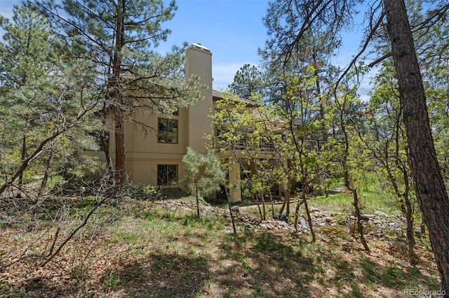474 Silbrico Way, Castle Rock, CO 80108 - view of property exterior with stucco siding and a chimney