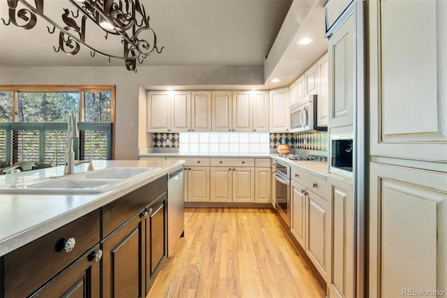 474 Silbrico Way, Castle Rock, CO 80108 - kitchen with stainless steel appliances, light countertops, light wood finished floors, tasteful backsplash, and recessed lighting