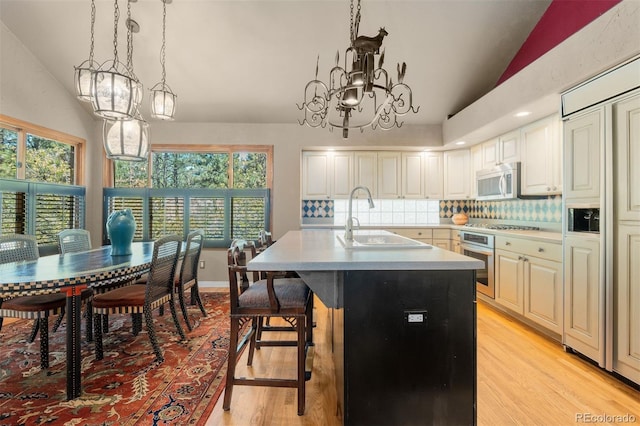 474 Silbrico Way, Castle Rock, CO 80108 - kitchen with stainless steel oven, light wood-style flooring, light countertops, tasteful backsplash, and pendant lighting
