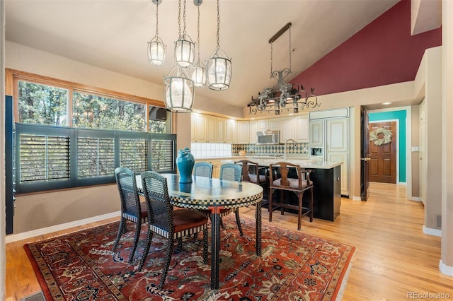 474 Silbrico Way, Castle Rock, CO 80108 - dining area with a chandelier, light wood-style flooring, and high vaulted ceiling