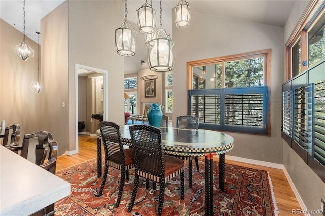 474 Silbrico Way, Castle Rock, CO 80108 - dining space with healthy amount of natural light, wood finished floors, and high vaulted ceiling