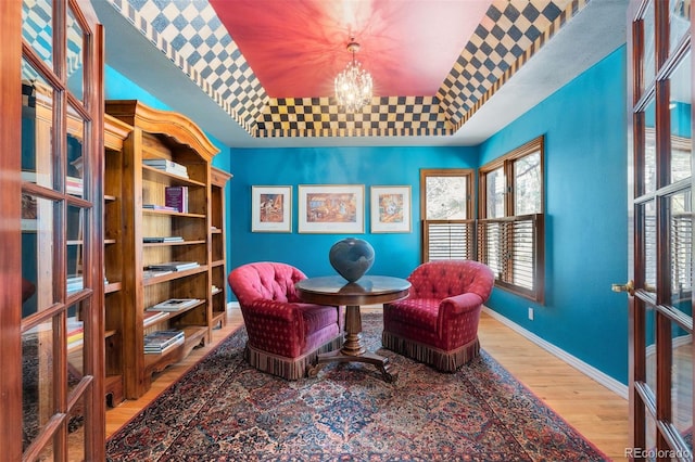 474 Silbrico Way, Castle Rock, CO 80108 - sitting room featuring a tray ceiling, wood finished floors, and a chandelier