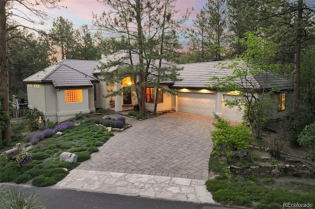 474 Silbrico Way, Castle Rock, CO 80108 - view of front of home with decorative driveway, stucco siding, a garage, and a tile roof