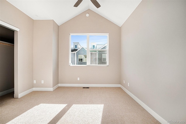 unfurnished bedroom featuring light carpet, ceiling fan, lofted ceiling, and a closet