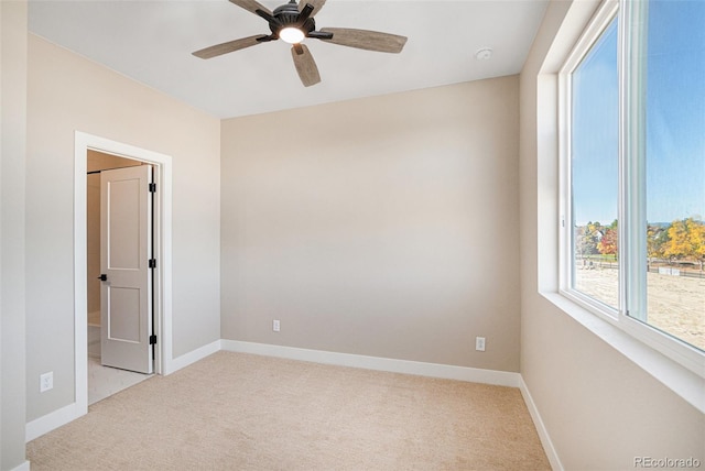 empty room with light carpet and ceiling fan