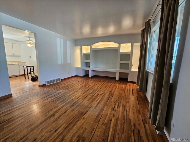 unfurnished living room featuring hardwood / wood-style flooring and ceiling fan