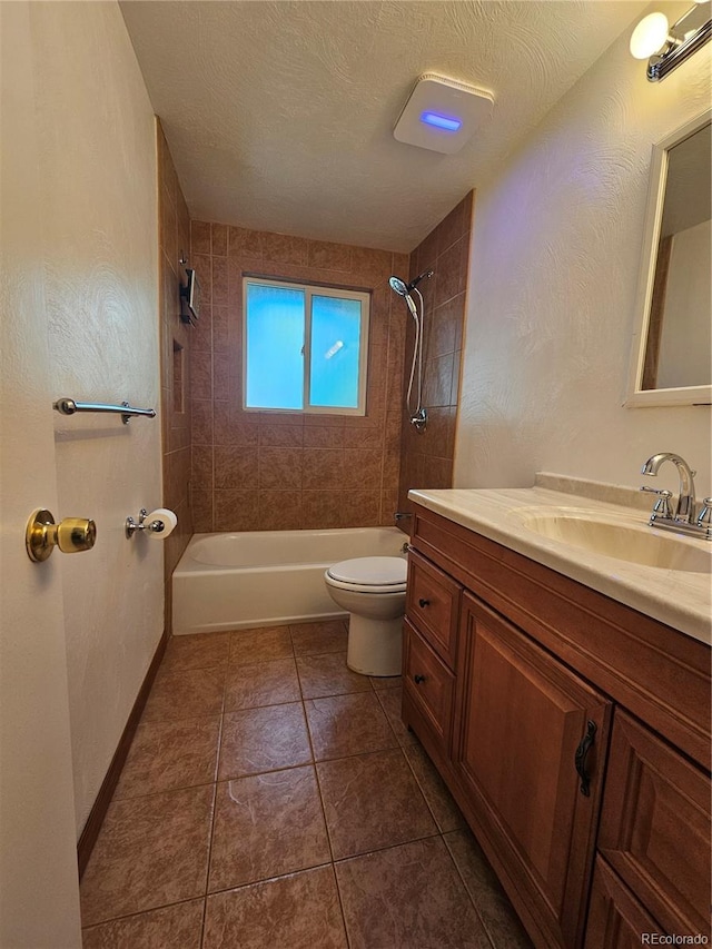 full bathroom featuring toilet, a textured ceiling, vanity, tiled shower / bath combo, and tile patterned flooring