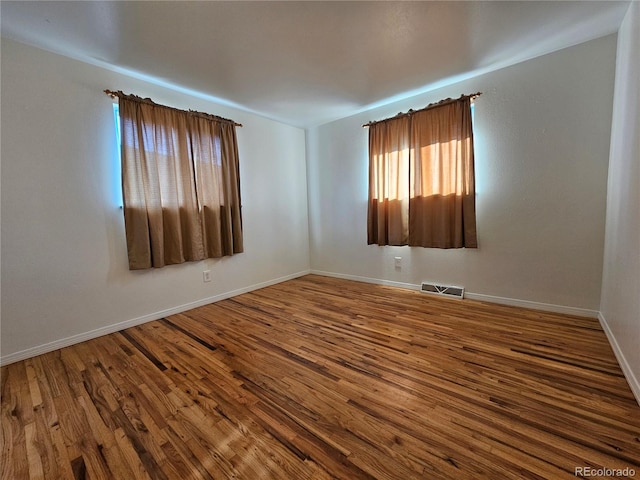 empty room featuring hardwood / wood-style floors