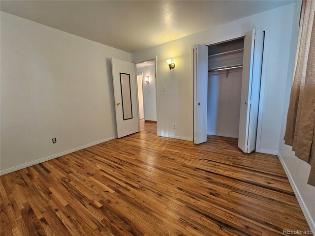 unfurnished bedroom featuring a closet and light hardwood / wood-style flooring