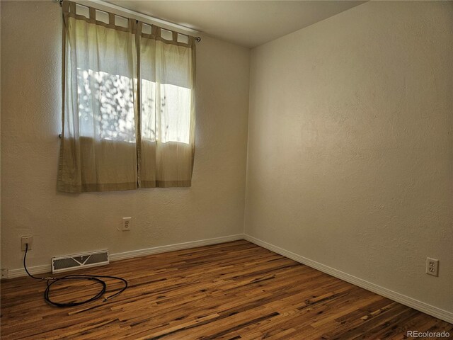 empty room featuring hardwood / wood-style flooring