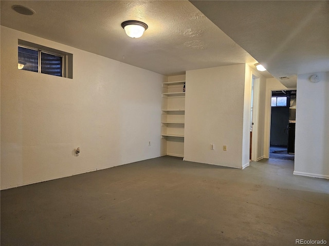 basement featuring a textured ceiling