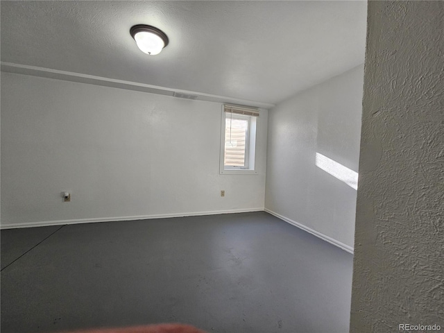 unfurnished room with concrete floors