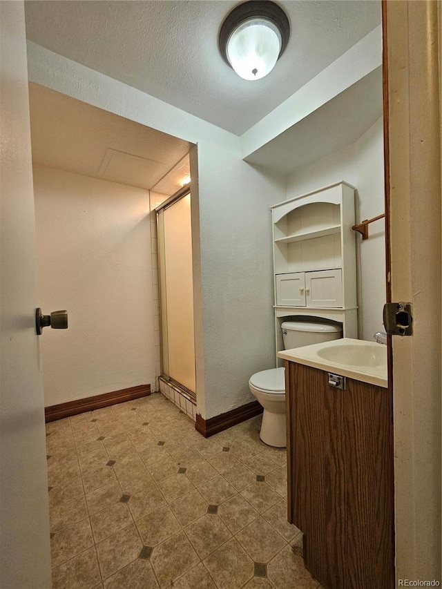 bathroom featuring vanity, a textured ceiling, and toilet